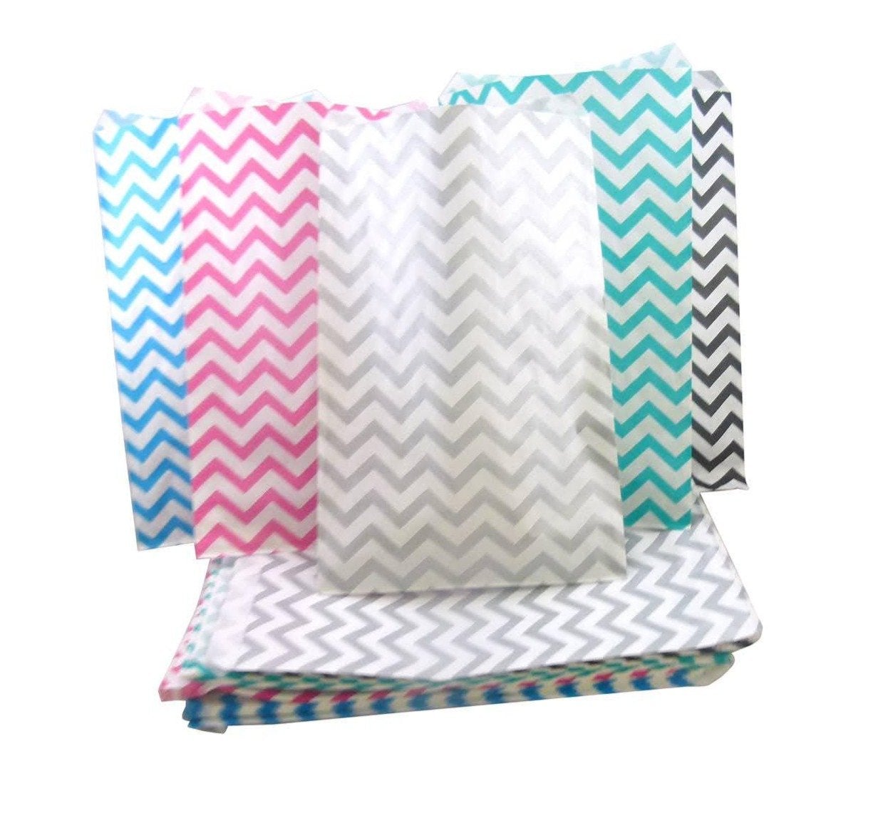 A collection of paper envelope bags, with black, blue, pink, silver and teal chevron patterns.